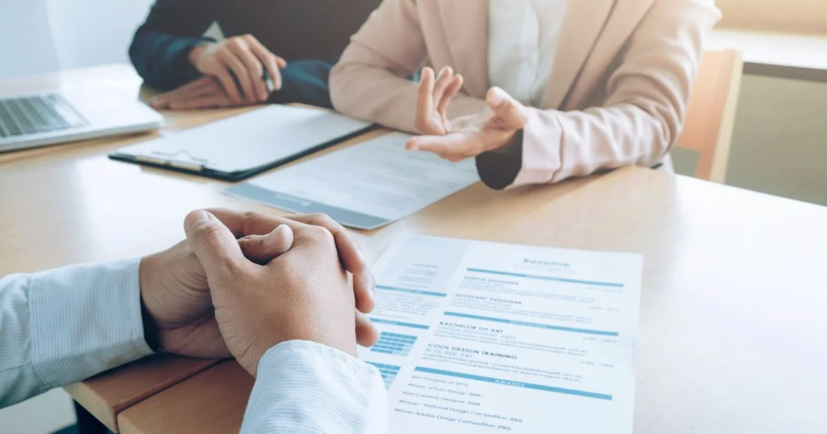 Job candidate reviewing documents during in-person interview meeting