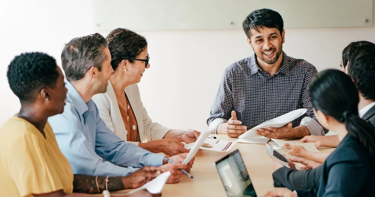 Team meeting discussing reports at conference table